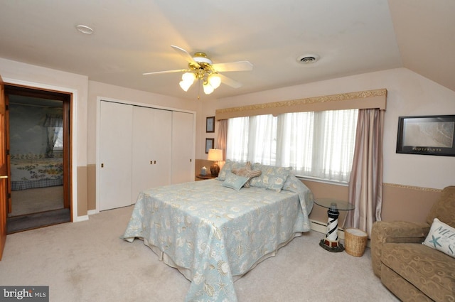 bedroom featuring visible vents, carpet, vaulted ceiling, a closet, and a ceiling fan