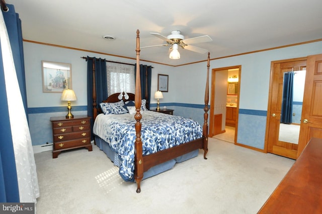 carpeted bedroom with a wainscoted wall, refrigerator, visible vents, and ornamental molding