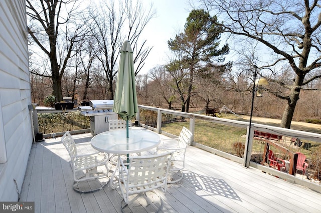 wooden terrace with outdoor dining area