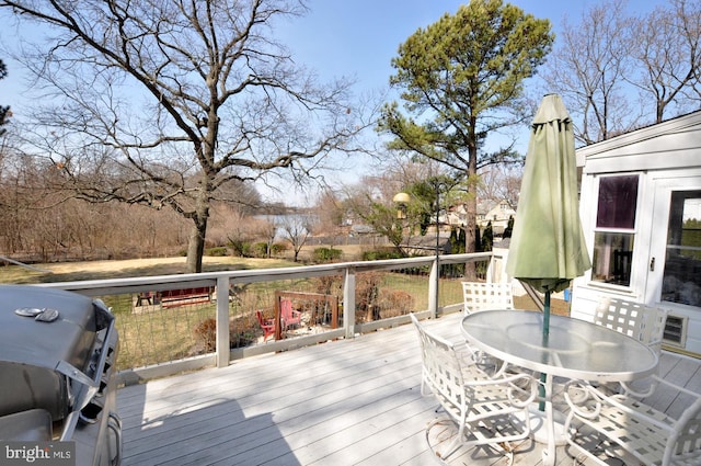 wooden deck featuring outdoor dining area and grilling area