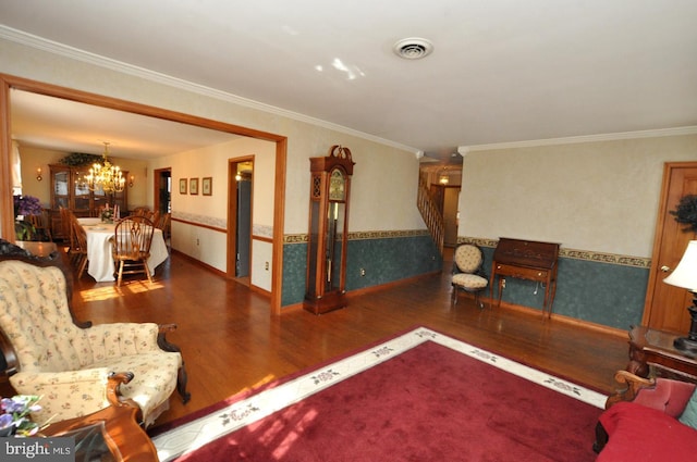 living room featuring visible vents, wallpapered walls, stairs, an inviting chandelier, and wood finished floors