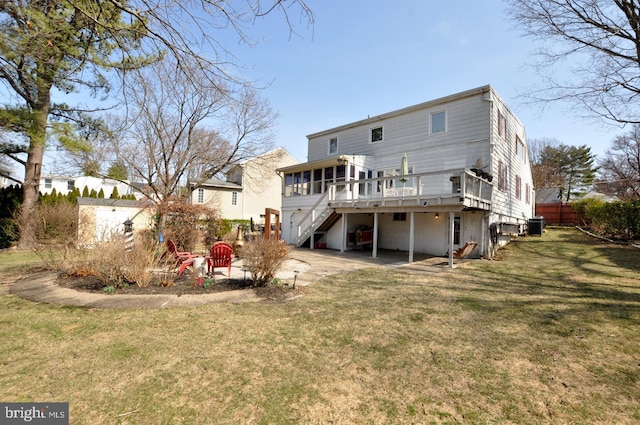 back of house with a lawn, driveway, a patio, stairway, and a wooden deck