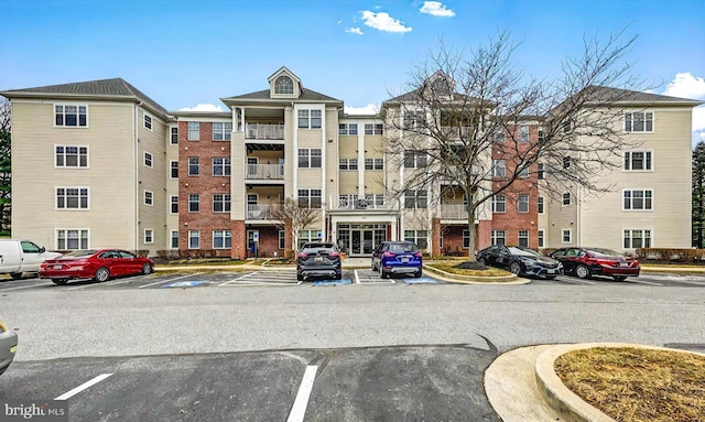 view of property featuring uncovered parking