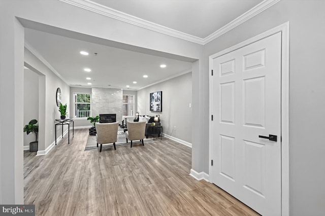 office area featuring ornamental molding, light wood-type flooring, a high end fireplace, and baseboards