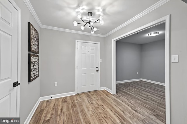 foyer with crown molding, baseboards, and wood finished floors