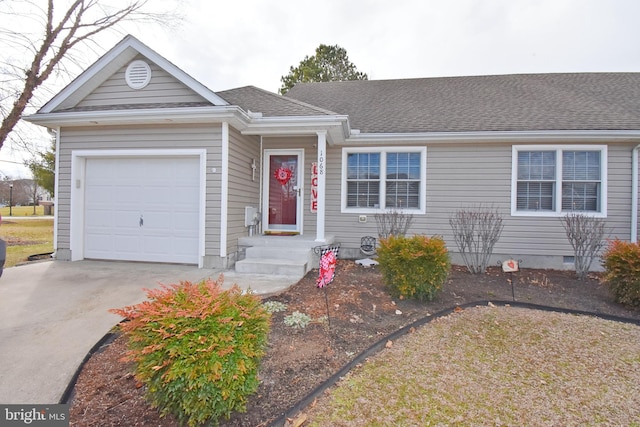 single story home featuring concrete driveway, a shingled roof, and an attached garage