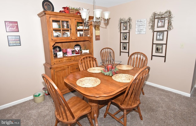 dining area featuring a chandelier, carpet floors, and baseboards