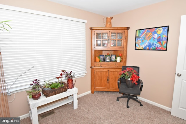 sitting room featuring light carpet, visible vents, and baseboards