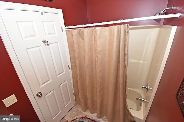 bathroom with shower / bathtub combination with curtain