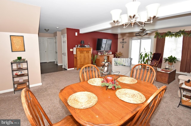 dining space with carpet, baseboards, and a chandelier