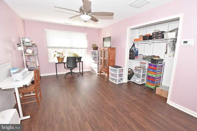 home office featuring a ceiling fan, visible vents, baseboards, and wood finished floors