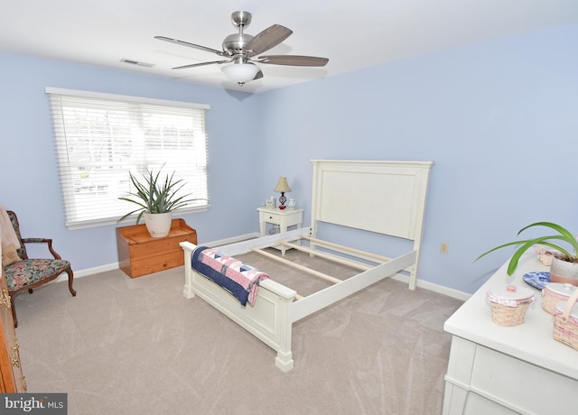 bedroom with a ceiling fan, light carpet, visible vents, and baseboards