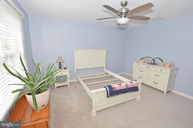 bedroom featuring light carpet, visible vents, and baseboards