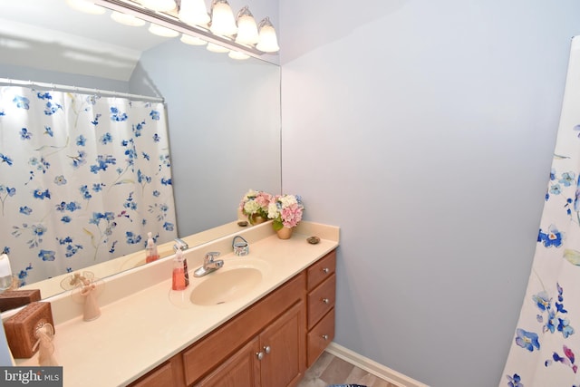 bathroom with vanity and baseboards