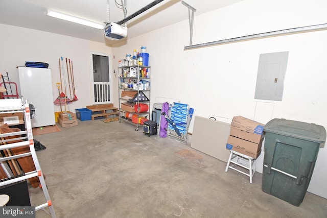 garage featuring white refrigerator, electric panel, and a garage door opener