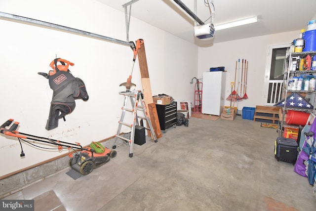 garage featuring fridge and a garage door opener