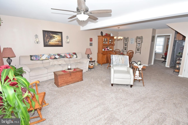 carpeted living room with baseboards and ceiling fan with notable chandelier