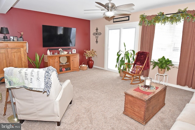 living area featuring carpet, ceiling fan, and baseboards