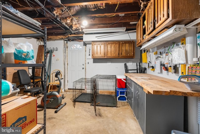 unfinished basement featuring a workshop area