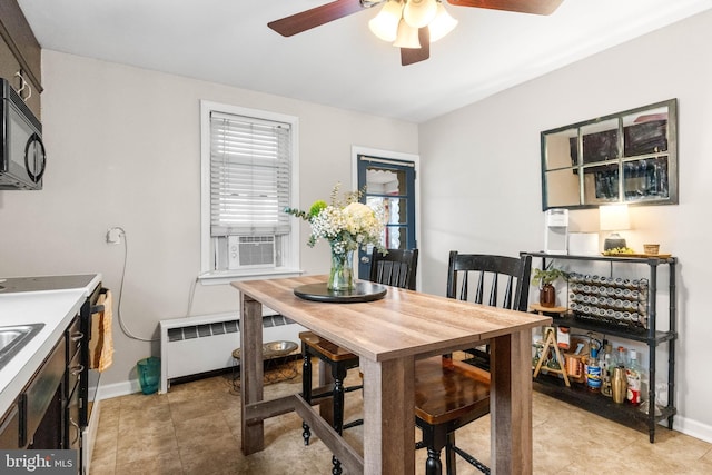 dining room featuring ceiling fan, light tile patterned floors, cooling unit, baseboards, and radiator heating unit