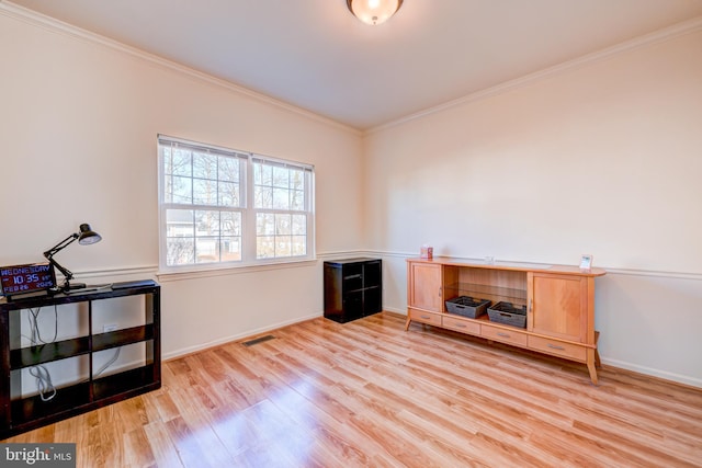 interior space featuring light wood-style floors, visible vents, ornamental molding, and baseboards