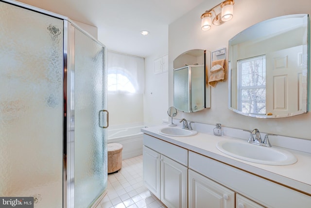 full bathroom with a stall shower, tile patterned flooring, a garden tub, and a sink