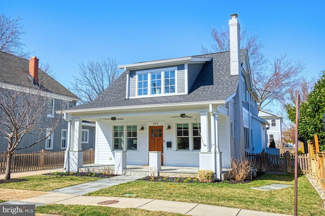 bungalow featuring a chimney, a porch, a shingled roof, a front yard, and fence