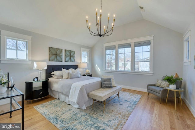 bedroom with lofted ceiling, baseboards, visible vents, and light wood-style floors