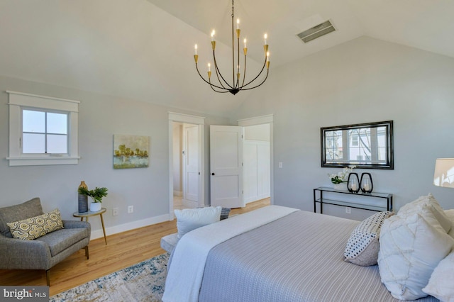 bedroom featuring high vaulted ceiling, baseboards, visible vents, and wood finished floors