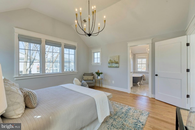 bedroom with light wood-style floors, a notable chandelier, vaulted ceiling, and baseboards