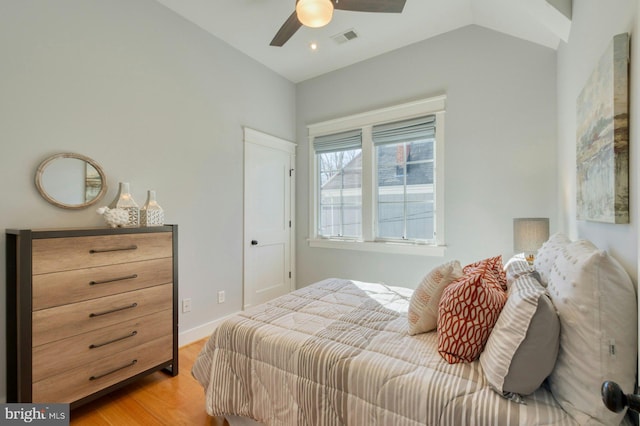 bedroom featuring baseboards, visible vents, lofted ceiling, ceiling fan, and light wood-type flooring