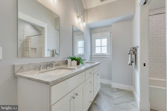 full bathroom with visible vents, a sink, baseboards, and double vanity