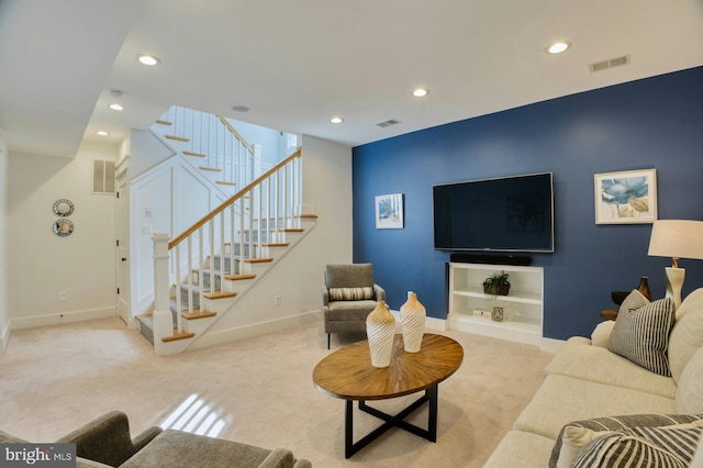 carpeted living room featuring baseboards, stairs, visible vents, and recessed lighting