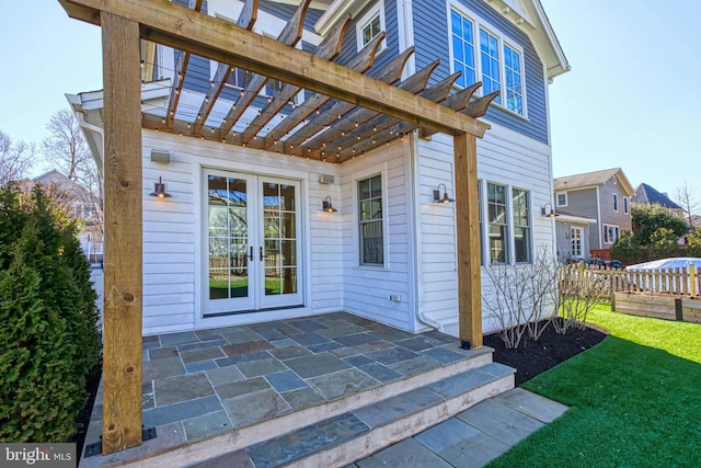 property entrance featuring fence, a yard, french doors, a pergola, and a patio area