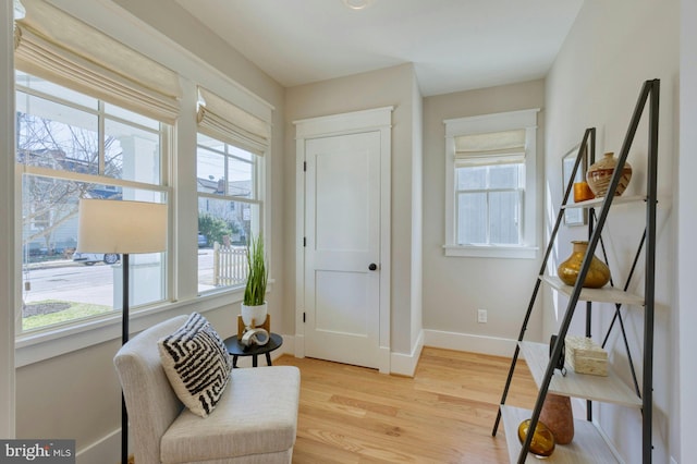 living area with light wood finished floors and baseboards