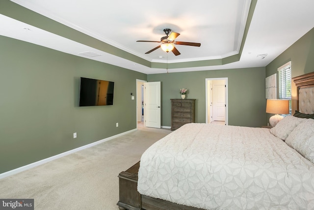 bedroom featuring carpet, ornamental molding, baseboards, visible vents, and a tray ceiling