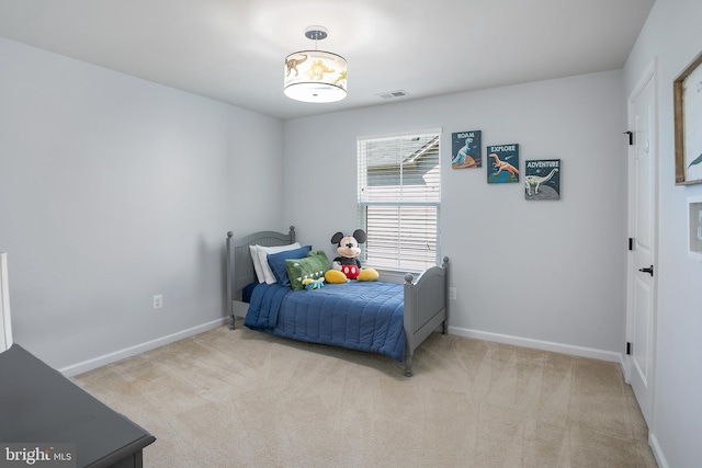carpeted bedroom with baseboards and visible vents