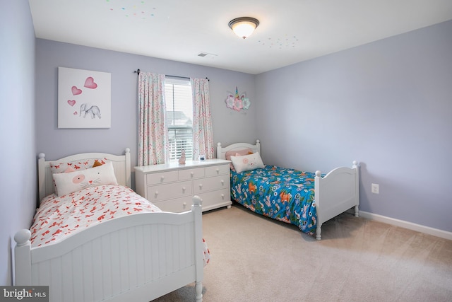 bedroom featuring visible vents, light colored carpet, and baseboards