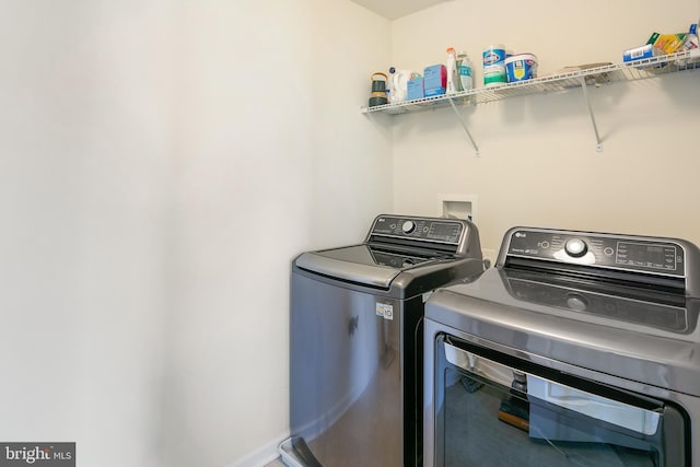 washroom with independent washer and dryer and laundry area