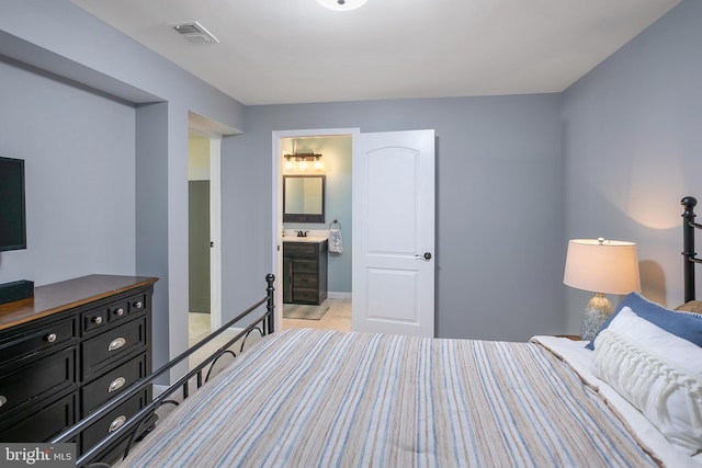 bedroom featuring visible vents and ensuite bathroom