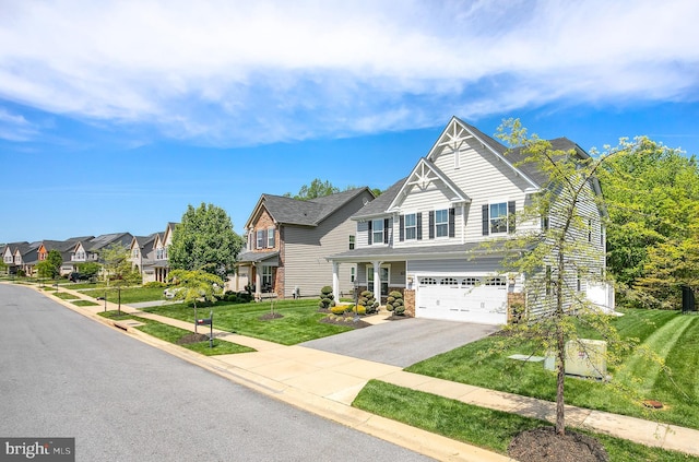 view of front of house with a front yard, aphalt driveway, a residential view, and a garage