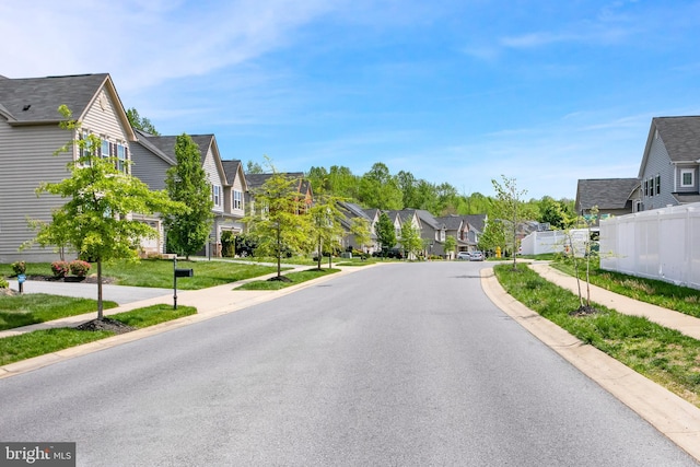view of road with curbs, sidewalks, and a residential view