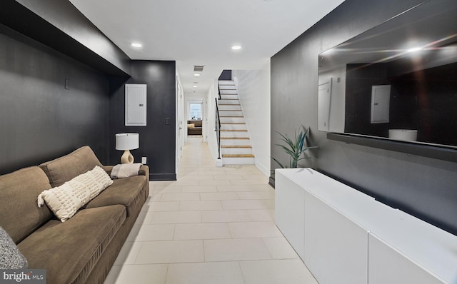 living room featuring electric panel and light tile patterned floors