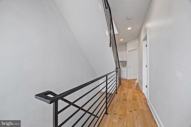 hallway with light hardwood / wood-style floors