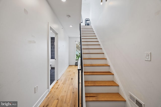 staircase featuring wood-type flooring