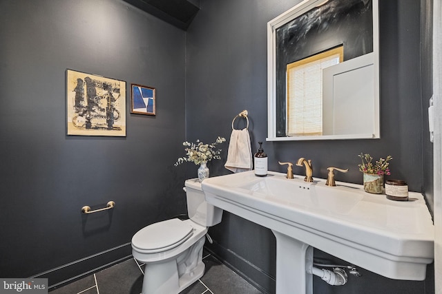 bathroom featuring sink, tile patterned flooring, and toilet