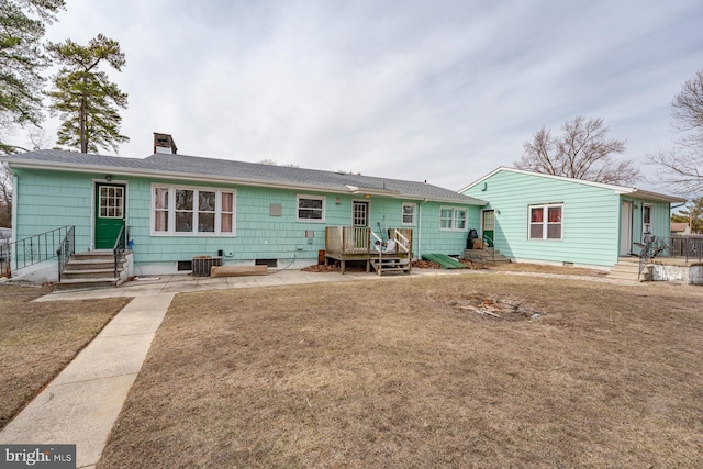 back of house featuring a patio, a yard, and central AC