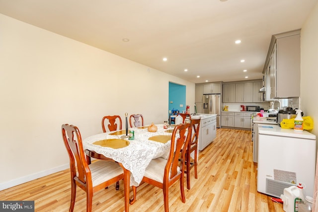 dining area with light hardwood / wood-style floors and sink