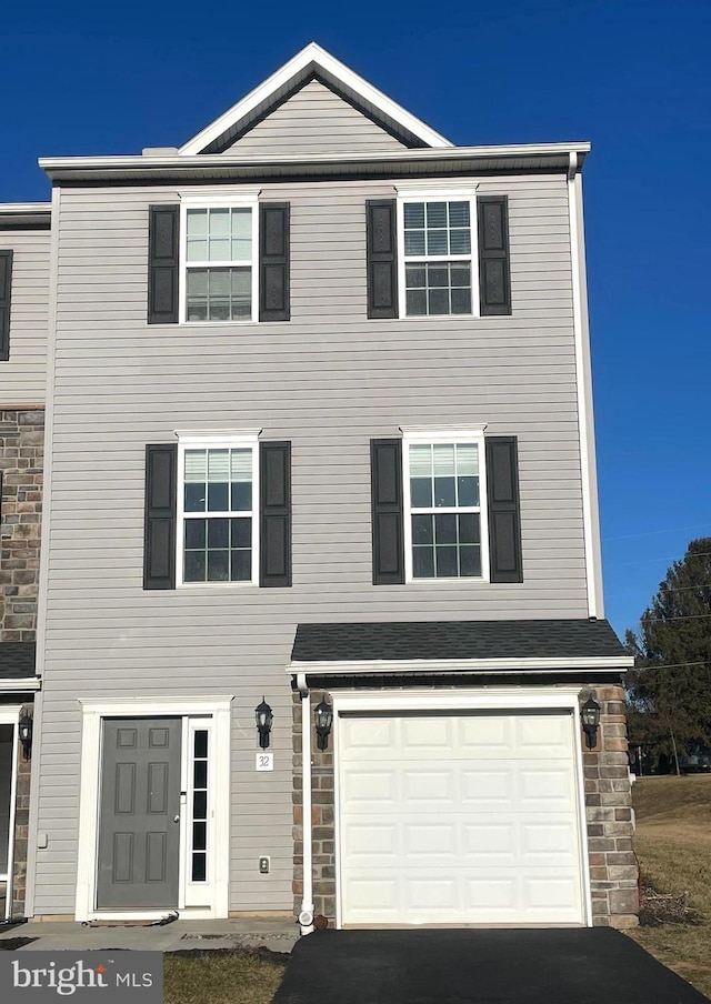 view of front facade with driveway and an attached garage