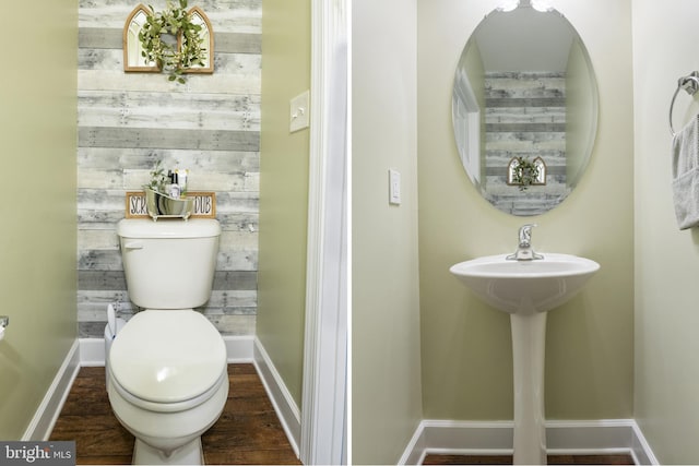 half bath featuring baseboards, toilet, wood finished floors, and wooden walls